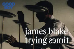 Text: "james blake trying times". Schattenhafte Person balanciert Teller auf Stöcken, blaues "GOOD BOY" Logo oben links.
