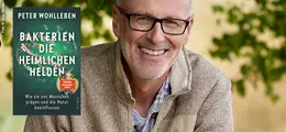 Peter Wohlleben: Bakterien - Die heimlichen Helden. Buchcover und lächelnder Mann in beiger Kleidung.