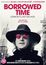 "BORROWED TIME: LENNON'S LAST DECADE. Schritt ins Leben einer Legende. Mit seltenen Archiven und exklusiven Geschichten. Illustration zeigt eine Person mit Hut und Brille, im Hintergrund Gebäude."