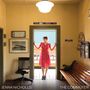 Texte: "JENNA NICHOLLS," "THE COMMUTER," "MONEY ORDERS," "BUS STOP TICKETS." Frau im roten Kleid steht lächelnd in einer Tür., CD