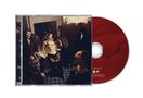 Roter CD-Hintergrund. Cover zeigt Menschen in Kostümen in einem dunklen Raum. Links CD-Hülle, rechts die CD., CD