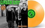 "GREEN DAY" und "WARNING:". Drei Männer laufen auf einer Straße. Daneben eine orangefarbene Schallplatte mit grünem Etikett., LP