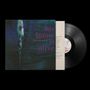 Texte: "his name is alive", "HOME IS IN YOUR HEAD". Dunkler Hintergrund, skulpturartige Figur links, Vinyl-Schallplatte rechts.