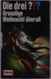 "Die drei ??? Gruselige Weihnacht überall" steht oben. Eine finstere, tierartige Gestalt mit Hörnern vor einem gelblichen Mond.