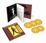 "ELVIS COSTELLO", "MY AIM IS TRUE" auf CDs und Buchcover, gelber Hintergrund mit schwarzem Foto einer Person.