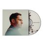 Text: "JORDAN RAKEI". 

Ein Mann im Profil, Schallplatte teilweise sichtbar.