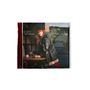 "DAY AND NIGHT", "CARLY RAE JEPSEN". Eine Frau lehnt sich in einem Café an einen Tisch; trägt eine schwarze Lederjacke., CD