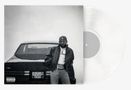 Schwarz-weiß Bild mit "Parental Advisory" Text. Mann lehnt an Auto, trägt Mütze, Jacke, T-Shirt und Jeans. Schallplatte hinten., LP