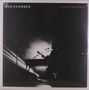 Text: "GAZ COOMBES", "LIVE IN PARIS". Silhouette eines Musikers mit Gitarre und Mikrofon vor hellem Licht.