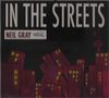 Texte: "IN THE STREETS", "NEIL GRAY", "CELLAR". Illustration: Bunte, schiefe Hochhäuser vor dunklem Hintergrund., CD