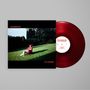 Text: "TRANSMITTER CUT WORMS". Rotes Vinyl. Person auf Stuhl im Garten., LP
