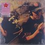 Text: "Elliott Smith". Der abgebildete Mensch trägt eine Mütze, sitzt in einem gedämpft beleuchteten Raum mit Kritzeleien., LP
