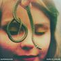 Texte: "SUPERHEAVEN", "OURS IS CHROME". Ein Kind mit geschlossenen Augen lächelt, hält eine kleine Schlange., LP