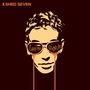 "Shed Seven", "Liquid Gold". Illustration: Gesicht mit Sonnenbrille, flüssiges Gold läuft aus den Gläsern., LP
