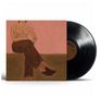 Text: „QUEST“
Gemälde einer sitzenden Figur mit tätowierten Armen, Vinyl daneben., Single 12"