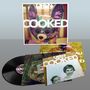 "OREN AMBARCHI COOKED DC994" steht auf einem Albumcover mit einem bunten Tier wie ein Plüschtier im Hintergrund., LP