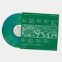 Der Text beschreibt eine Musik-Compilation: "The Anthology of UnAmerican Folk Music Vol. 1". Es zeigt eine grüne Vinylplatte., LP