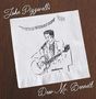 Text: "John Pizzarelli, Dear Mr. Bennett". Zeichnung eines Mannes mit Gitarre auf einer Serviette, Holzuntergrund.