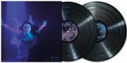 "Michl Jynoe Into The Waves" in geschwungener Schrift. Eine Person taucht in blauem Licht, daneben zwei Schallplatten.