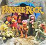 Text: "THE BEST OF FRAGGLE ROCK". Farbenfrohe Figuren in einer Höhle, die musizieren und fröhlich wirken., LP
