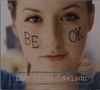 Auf den Wangen steht "BE OK", unten "ingrid michaelson". Ein Gesicht in Nahaufnahme blickt direkt.