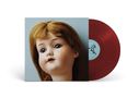 Ein rotes Vinyl und ein Albumcover mit einem großen Puppenkopf vor blauem Hintergrund., LP