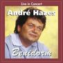 "Live in Concert André Hazes Benidorm." Ein Mann mit dunklem Haar schaut leicht zur Seite, Hintergrund in Gelbtönen., CD