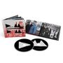 Text: "Depeche Mode Delta Machine". Zwei CDs mit schwarzem Design und ein aufgeschlagenes Booklet mit Bandfotos.