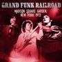 „Grand Funk Railroad, Madison Square Garden, New York 1972.“ Rötliche Konzertszene mit drei Musikern, einer mit Gitarre., CD