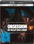 Text: "Sei vorsichtig, wen du dir wünschst... OBSESSION DU SOLLST MICH LIEBEN. Drehbuch und Regie Curry Barker."  
Ein Mann hält eine brennende Streichholzschachtel im Auto.