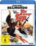 „Jean-Paul Belmondo, Raquel Welch, Ein irrer Typ“ in großen Buchstaben, darunter chaotische Szenen mit Hubschrauber.