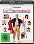 Text: "Eine Wahnsinnsfamilie", "FSK ab 12 freigegeben". Ein Mann hält zwei Kinder kopfüber; mehrfach gerahmte Fotos im Hintergrund.