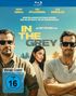 Text: "Henry Cavill, Jake Gyllenhaal, Eiza González, Wenn Milliarden gestohlen werden...", "IN THE GREY", FSK 16.   
Drei Personen, Palmen im Hintergrund.