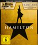 "VORLÄUFIGE ABBILDUNG" oben in Schwarz. Mehrere CDs, Fotos, ein Buch und eine Box mit "HAMILTON"-Logo und Sternmotiv.