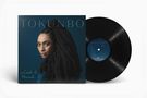 Albumcover mit "TOKUNBO" und "Lost & Found". Eine Frau mit langen Haaren blickt zur Seite. Schallplatte daneben., LP