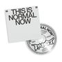"THIS IS NORMAL NOW" steht auf einem quadratischen Blatt. Eine CD zeigt das gleiche Motto und ein stilisiertes Logo., CD