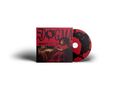 Text: "DOGMA". Illustration: Ein Mann in rotem Gewand sitzt nachdenklich auf einem Stuhl. CD mit ähnlichem Design., CD