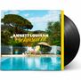 Text: "ANNETT LOUISAN Sehnsucht". Eine Frau sitzt an einem Pool, umgeben von Natur und Liegestühlen., LP