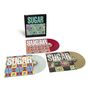 "SUGAR" steht auf Plattenhüllen, drei bunte Schallplatten, geometrische Muster, lebendige Farben., 3 LPs