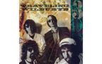 "TRAVELING WILBURYS" in großer Schrift. Vier Männer mit Sonnenbrillen, vor einem abstrakten, erdfarbenen Hintergrund., CD