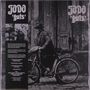 Text: "Jodo 'guts'. Early '70s heavy-rock with blues, hard rock and proto-metal influences by this British band."

Ein Mann mit Hut schiebt ein altes Fahrrad vor einer Holztür. Links sind unscharf zwei Gesichter erkennbar., LP