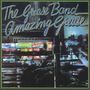 "The Grease Band Amazing Grease" in stilisierter Schrift. Leuchtreklamen vor einem nächtlichen Stadthintergrund., CD