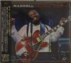 „HARRELL TALKIN' HEAVY“ steht oben. Ein Mann spielt Gitarre und singt vor einem Mikrofon mit geschlossenen Augen.
