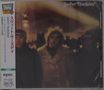 Japanese text along the side, "Sweet Thursday" at the top. Blurry image of three individuals in winter coats.