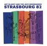 Text: ART BLAKEY AND THE JAZZ MESSENGERS, STRASBOURG 82. Illustration: Skizze einer Stadt mit Kirchen und Gebäuden in Farbblöcken., 2 LPs