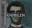 Texte: "GOBLIN", japanische Schriftzeichen. Illustration eines Mannes mit energischem Gesichtsausdruck vor blauem Hintergrund.