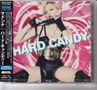Text: "HARD CANDY" in großen weißen Buchstaben. Eine Frau in schwarzem Outfit und Handschuhen vor einem rosa Hintergrund.