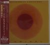 „BEATIE WOLFE & BRIAN ENO LUMINOL“ oben und unten. Orangefarbener, abstrakter Kreis auf gelbem Hintergrund., CD