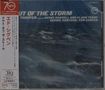 "OUT OF THE STORM" oben in großen Buchstaben. Unten eine stürmische Meereslandschaft. Japanische Schriftzeichen links., CD