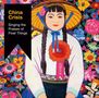 "China Crisis: Singing the Praises of Finer Things" auf schwarzem Banner. Illustrative Frau in bunter Tracht vor Blumenmuster., CD